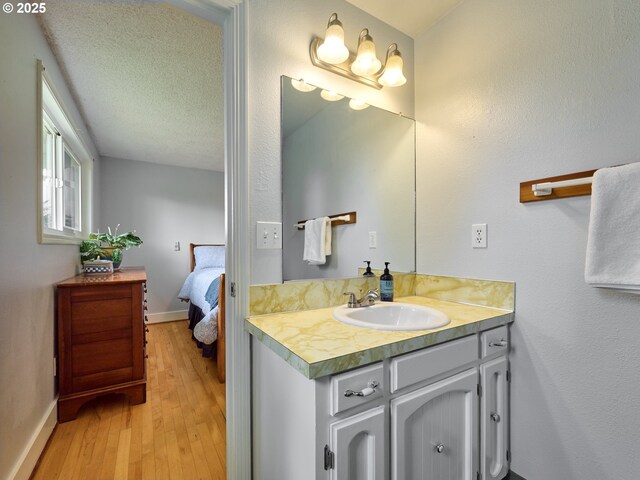 13601 S Union Hall Rd, Canby, OR 97013 - ensuite bathroom featuring hardwood / wood-style flooring, vanity, and baseboards