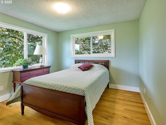 13601 S Union Hall Rd, Canby, OR 97013 - bedroom with light wood-style flooring, multiple windows, and a textured ceiling