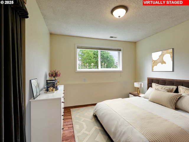 13601 S Union Hall Rd, Canby, OR 97013 - bedroom with wood finished floors and a textured ceiling