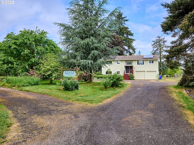 13601 S Union Hall Rd, Canby, OR 97013 - split foyer home featuring an attached garage, driveway, and roof mounted solar panels