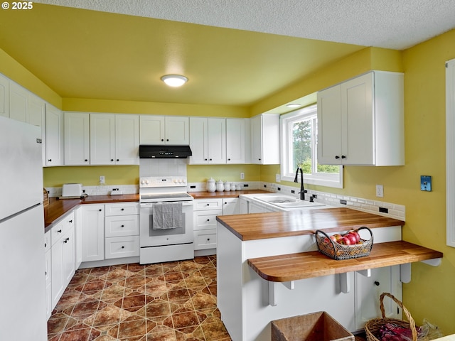13601 S Union Hall Rd, Canby, OR 97013 - kitchen with white appliances, under cabinet range hood, butcher block countertops, stone finish flooring, and white cabinetry