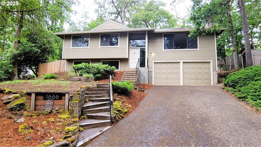 1666 W 28th Pl, Eugene, OR 97405 - raised ranch with driveway, stairs, and a garage