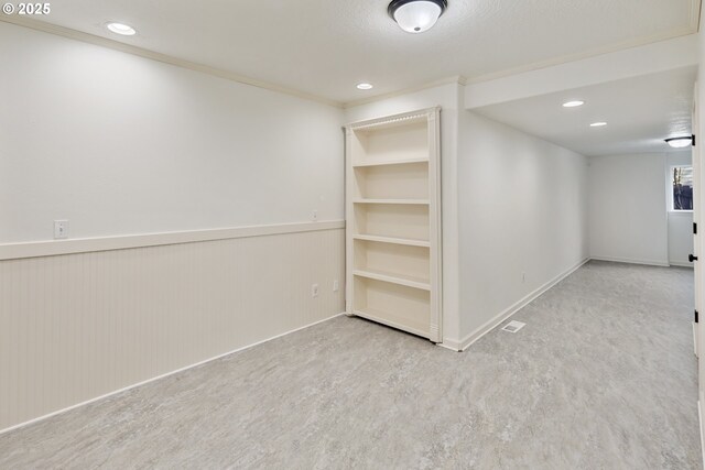 basement featuring crown molding and a textured ceiling