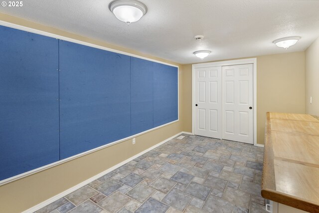 interior space with a textured ceiling