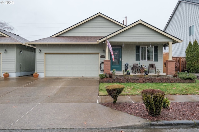 view of front facade with driveway, a shingled roof, a garage, and a porch