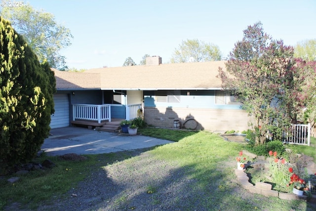 exterior space with a lawn, a chimney, and a porch
