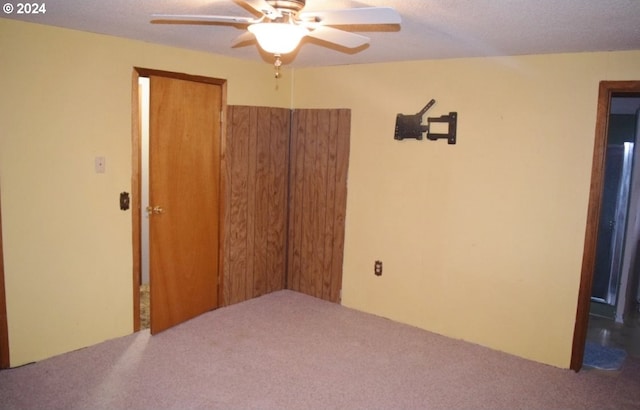 empty room with carpet and a ceiling fan