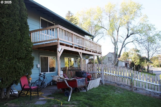 back of house with fence and a wooden deck