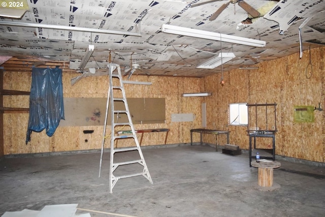 misc room with ceiling fan and concrete flooring