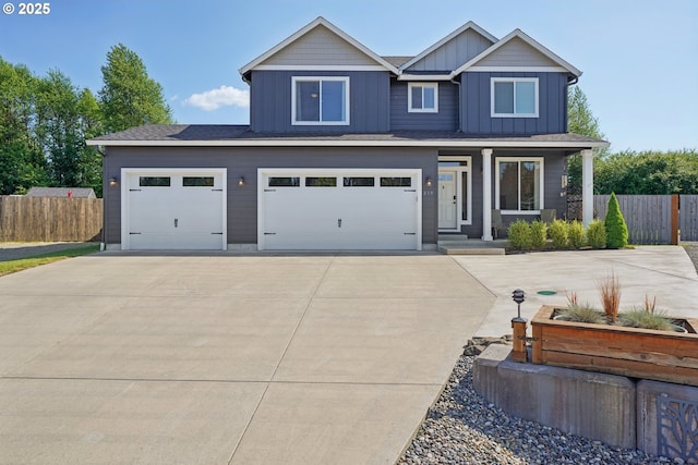 219 W Christy Ct, Yacolt, WA 98675 - view of front facade featuring concrete driveway, board and batten siding, an attached garage, and a porch