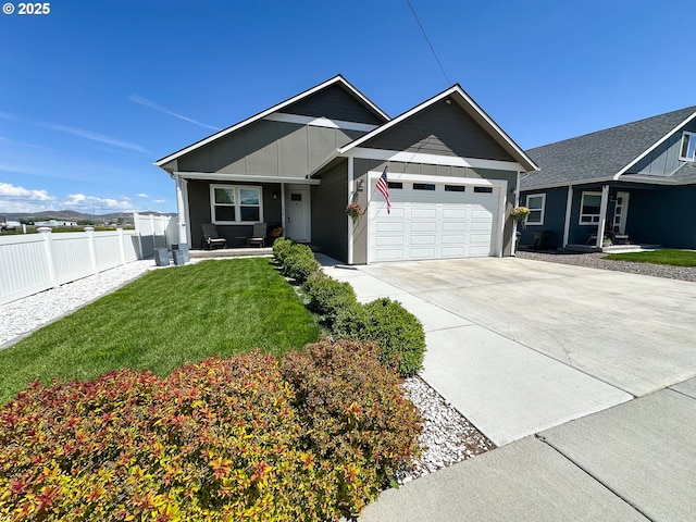 2950 Birch St, Baker City, OR 97814 - ranch-style house featuring a garage, driveway, board and batten siding, and covered porch