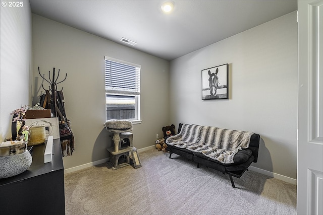 living area featuring carpet floors, baseboards, and visible vents