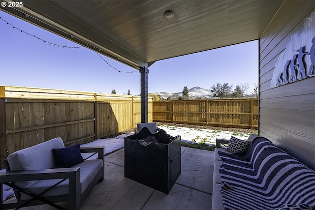 view of patio / terrace with a fenced backyard, a mountain view, and outdoor lounge area