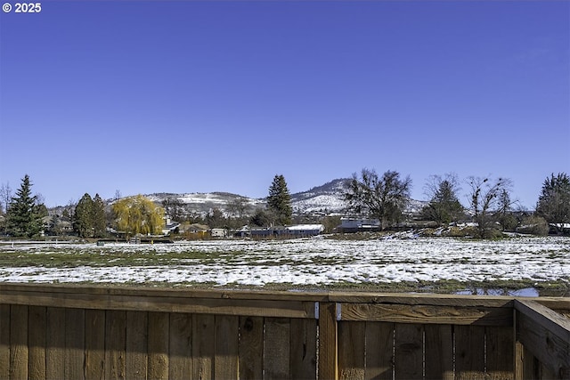 snowy yard with a mountain view