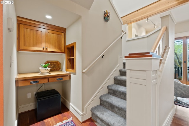 stairs with wood finished floors, baseboards, and recessed lighting