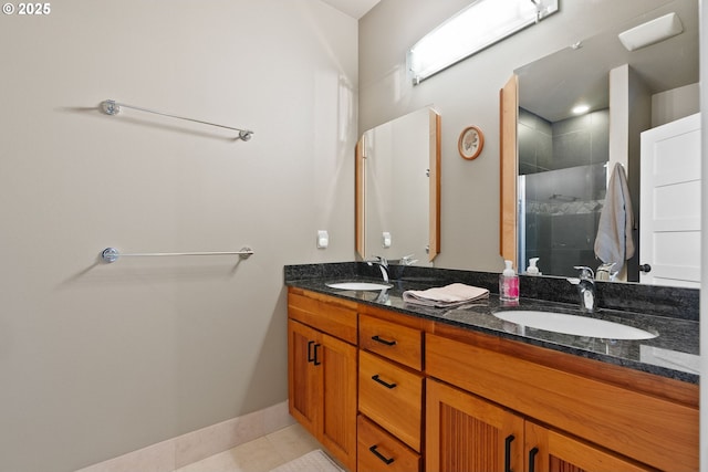 full bathroom with a sink, tile patterned floors, a stall shower, and double vanity