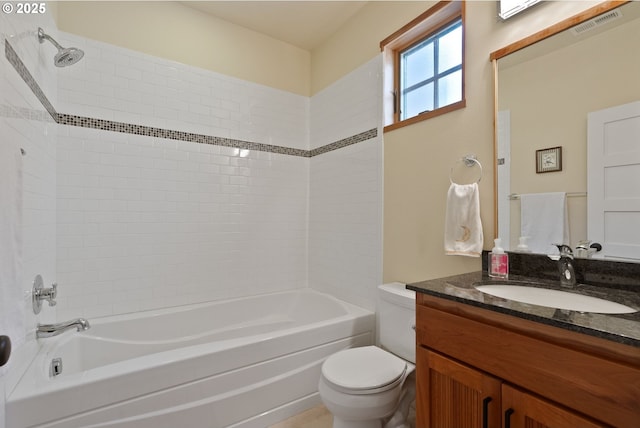 bathroom featuring toilet, visible vents,  shower combination, and vanity