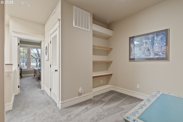 corridor with carpet flooring, baseboards, and visible vents