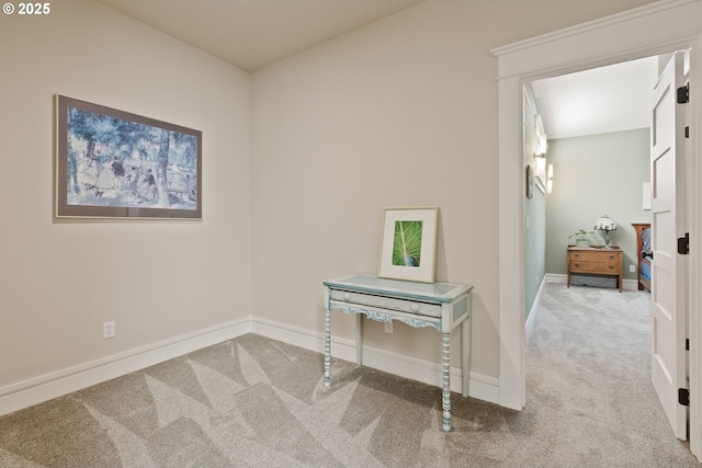 corridor featuring carpet flooring and baseboards