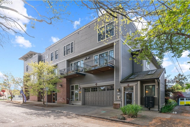 view of building exterior with concrete driveway and an attached garage