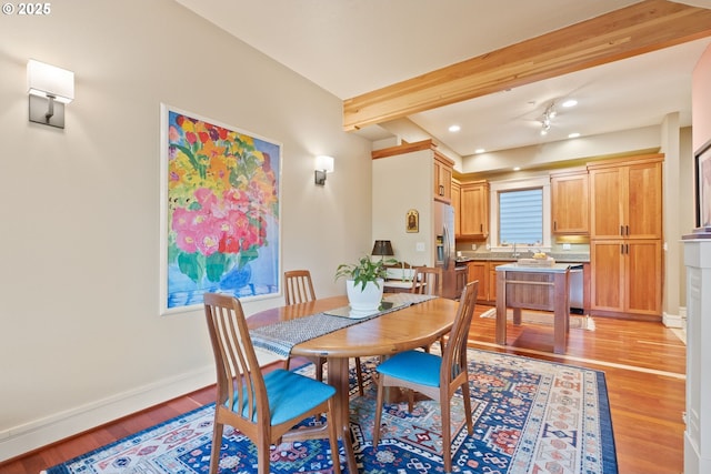 dining area featuring recessed lighting, light wood finished floors, baseboards, and beamed ceiling