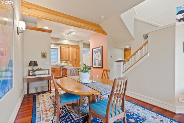dining area with baseboards, stairs, and wood finished floors