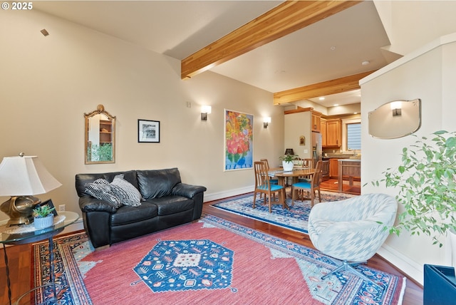 living room featuring baseboards, recessed lighting, wood finished floors, and beamed ceiling
