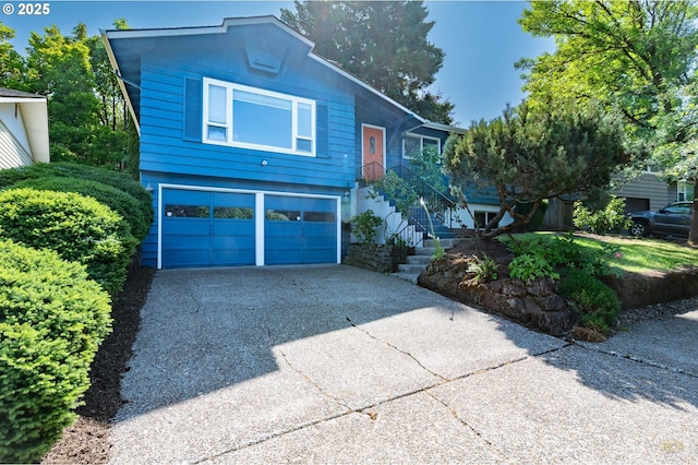7323 SW Nevada Ter, Portland, OR 97219 - view of front facade with driveway, a garage, and stairway