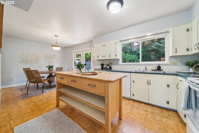 7323 SW Nevada Ter, Portland, OR 97219 - kitchen featuring open shelves, wood counters, white electric range, white cabinetry, and pendant lighting