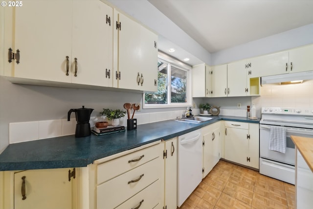 7323 SW Nevada Ter, Portland, OR 97219 - kitchen featuring white appliances, under cabinet range hood, dark countertops, backsplash, and recessed lighting