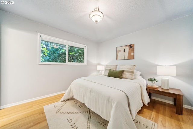 7323 SW Nevada Ter, Portland, OR 97219 - bedroom featuring baseboards and wood finished floors