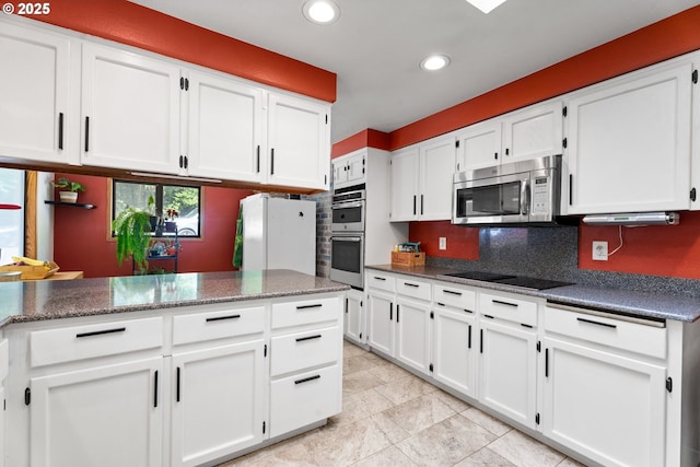 kitchen featuring appliances with stainless steel finishes, white cabinets, and recessed lighting