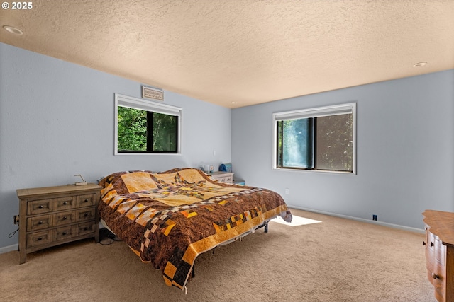 bedroom featuring carpet floors, a textured ceiling, and baseboards