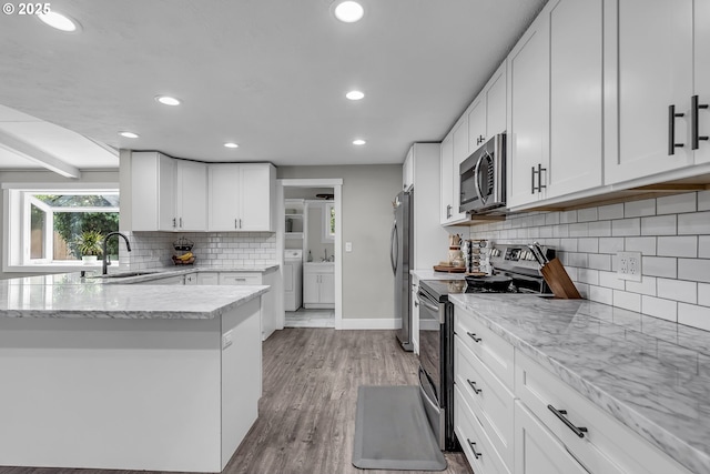1388 Hillendale Dr, Salem, OR 97302 - kitchen with stainless steel appliances, independent washer and dryer, recessed lighting, white cabinets, and decorative backsplash