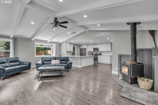 1388 Hillendale Dr, Salem, OR 97302 - living area featuring recessed lighting, ceiling fan, wood finished floors, and a wood stove