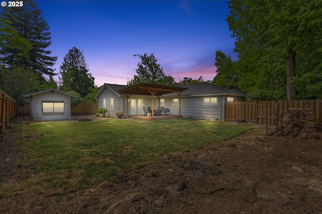1388 Hillendale Dr, Salem, OR 97302 - back of house at dusk with a pergola, a fenced backyard, and a patio area