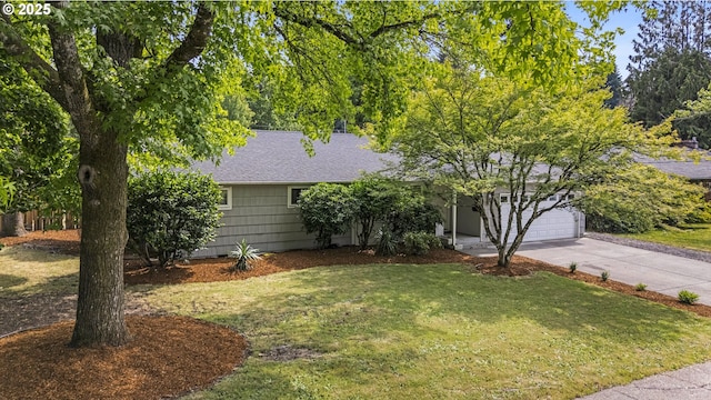 1388 Hillendale Dr, Salem, OR 97302 - view of property hidden behind natural elements with concrete driveway, a front lawn, a garage, and a shingled roof