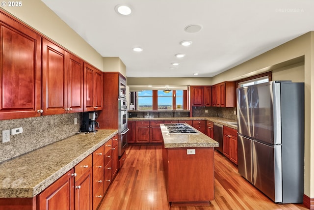 45585 NW David Hill Rd, Forest Grove, OR 97116 - kitchen featuring freestanding refrigerator, decorative backsplash, a kitchen island, dark wood-style floors, and plenty of natural light