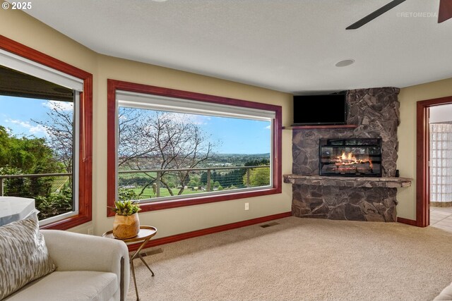 45585 NW David Hill Rd, Forest Grove, OR 97116 - carpeted living room with a ceiling fan, baseboards, visible vents, and a fireplace