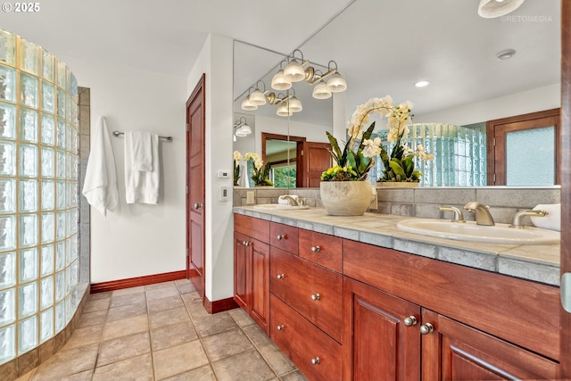 45585 NW David Hill Rd, Forest Grove, OR 97116 - bathroom featuring double vanity, baseboards, a healthy amount of sunlight, and a sink