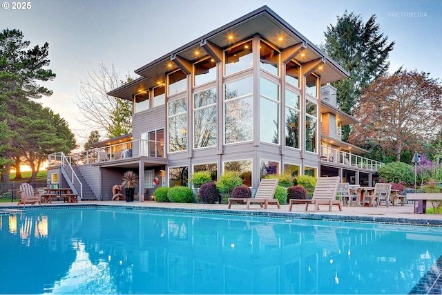 45585 NW David Hill Rd, Forest Grove, OR 97116 - rear view of property featuring stairs, an outdoor pool, and a patio area