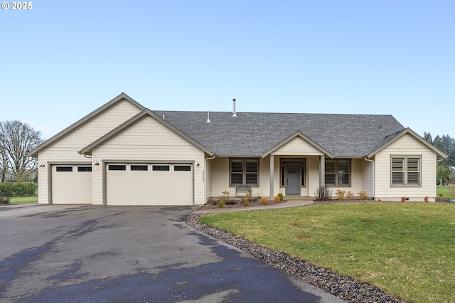 ranch-style home featuring a front lawn and a garage