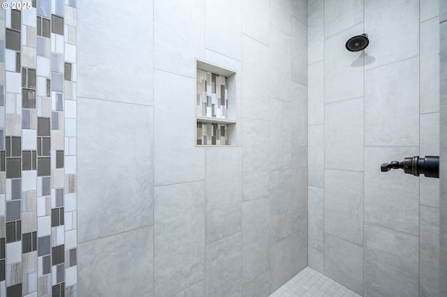 bathroom with a tile shower