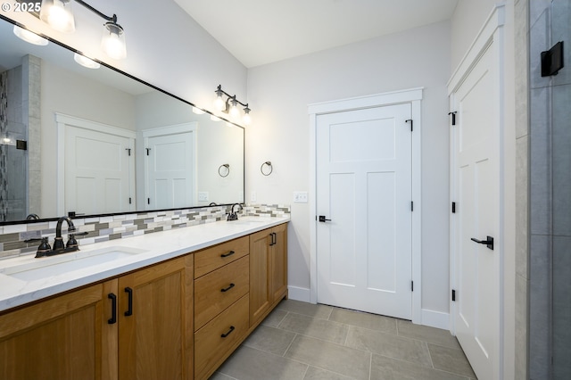 bathroom featuring decorative backsplash, tile patterned floors, and vanity