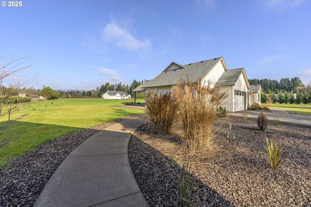 view of property exterior featuring a lawn and a garage