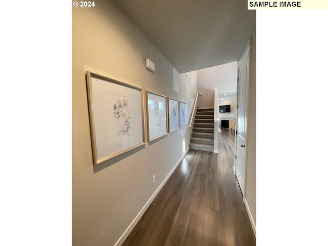2393 W 7th Ave, Junction City, OR 97448 - hallway with stairs, dark wood-style flooring, and baseboards