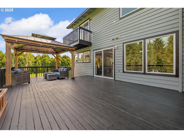 deck featuring a gazebo and an outdoor living space
