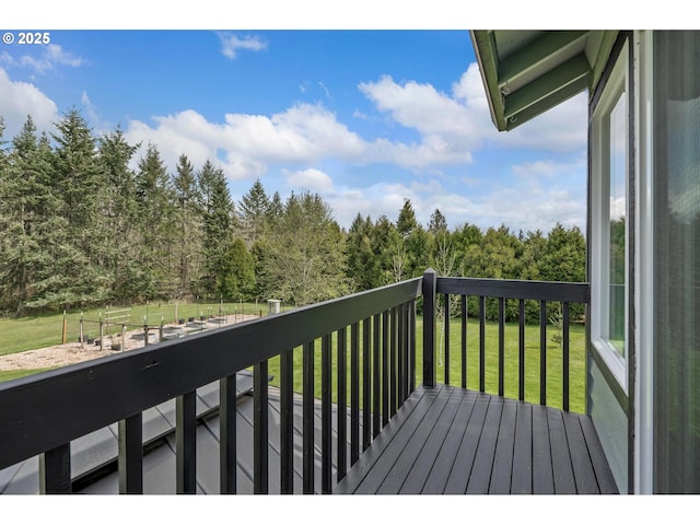balcony featuring a forest view