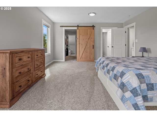 bedroom with baseboards, light colored carpet, and a barn door