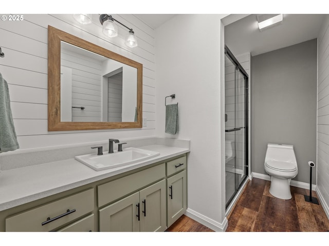 full bath featuring toilet, a shower stall, wood finished floors, and vanity